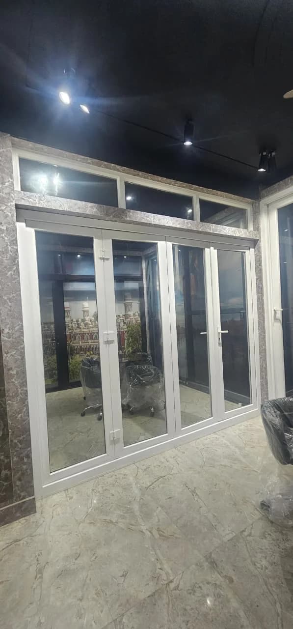 Tall white uPVC glazed doors under a row of fixed transom lights